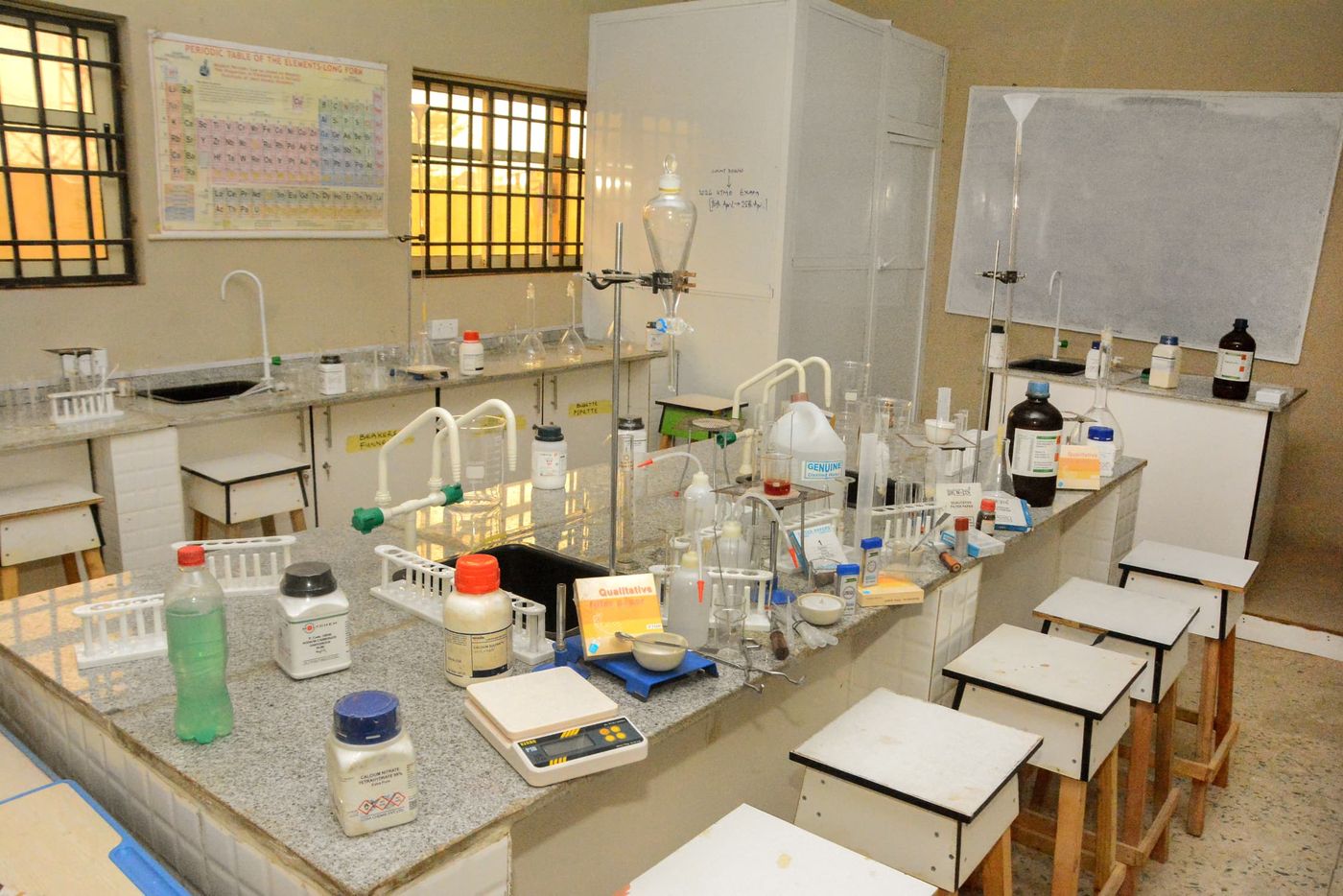 Chemistry laboratory with reagent bottles, glassware, and a fume-extraction unit