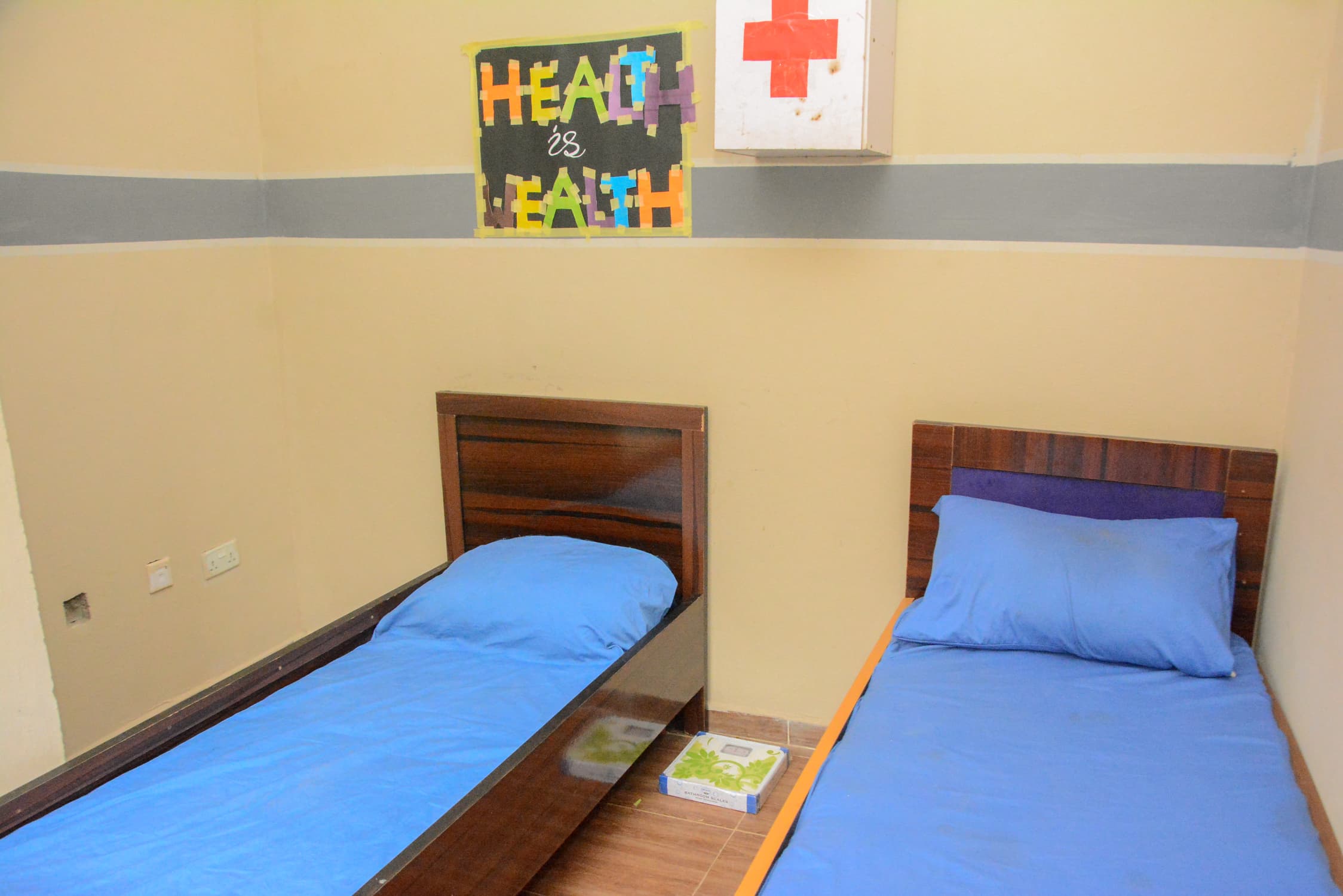 Sick Bay with two made beds and a first-aid cabinet